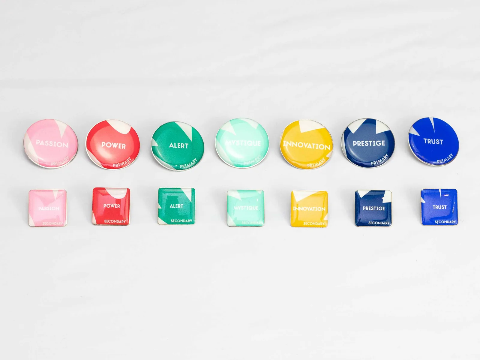 Seven round and seven square pins in the archetype colors