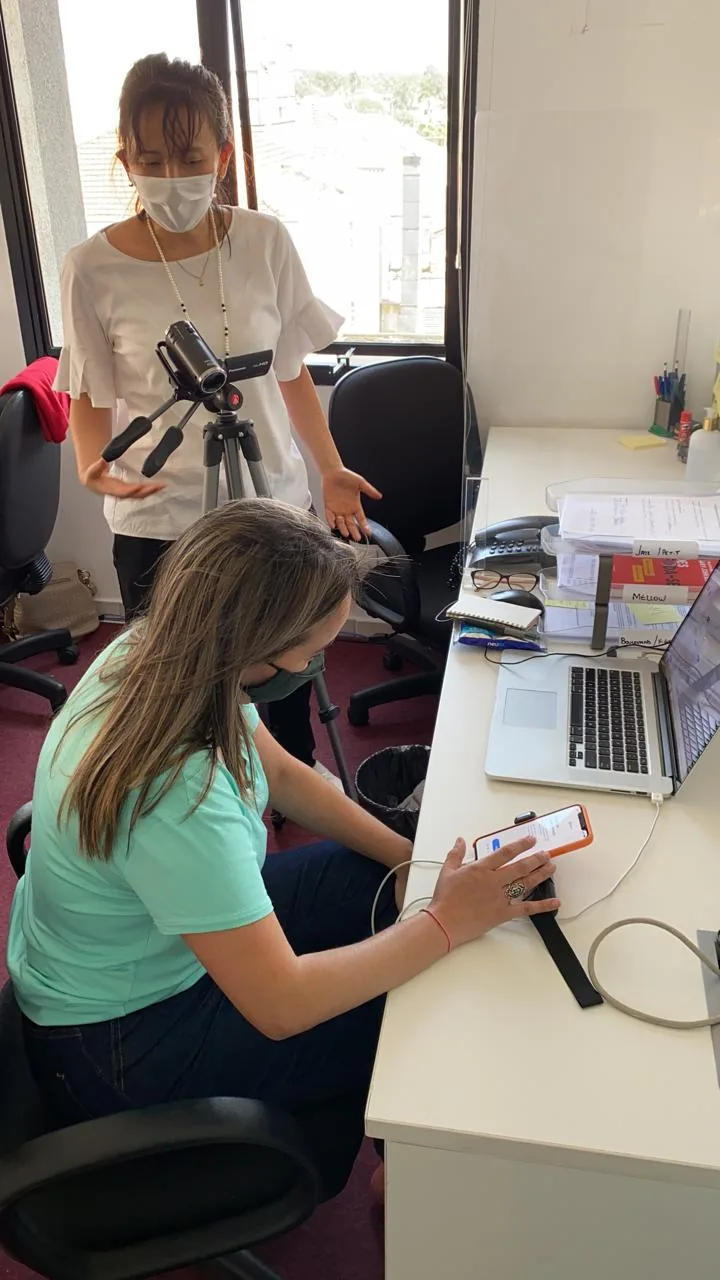 Usability test: a participant taps through the prototype on a phone while a researcher films the session